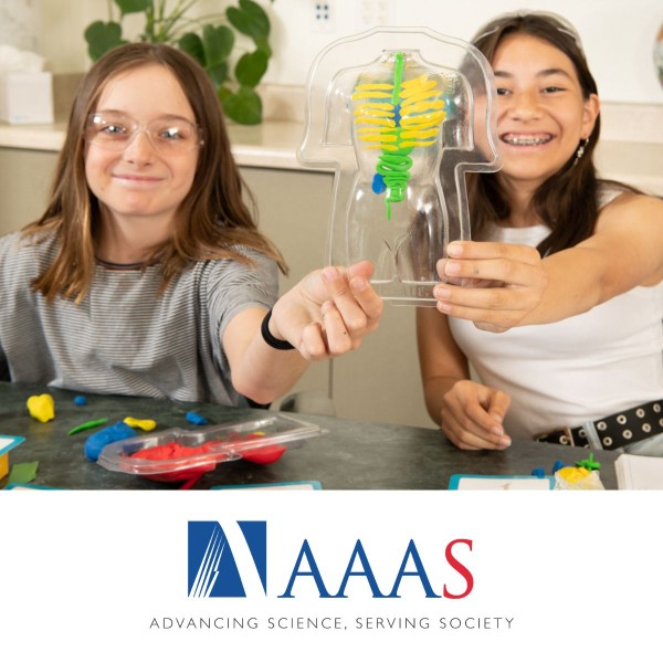 two young science students hold up a model of the body system they made